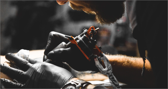 Tattoo artist applying tattoo