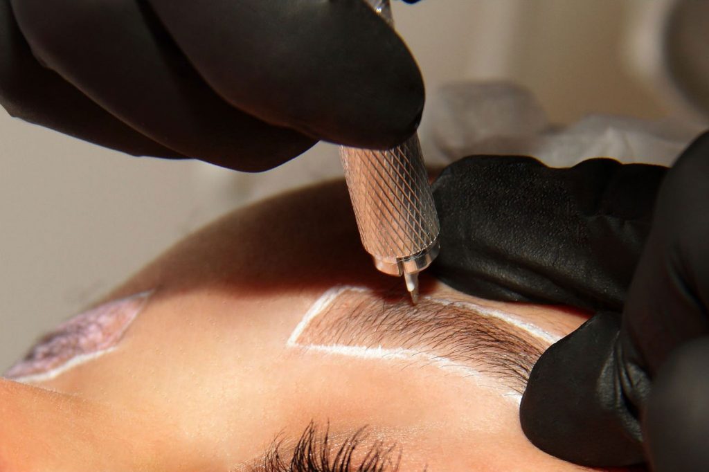 Woman receiving microblading treatment