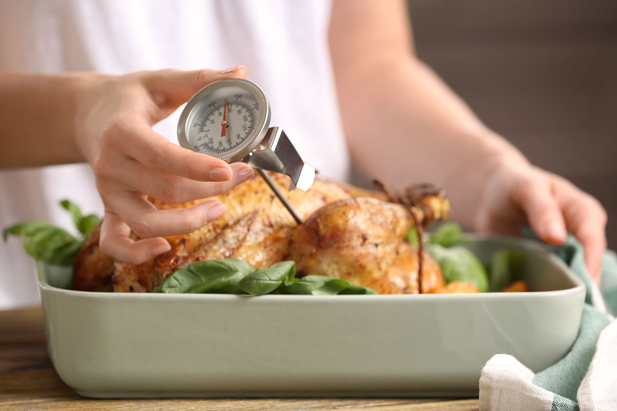 Cooked poultry with a heat thermometer