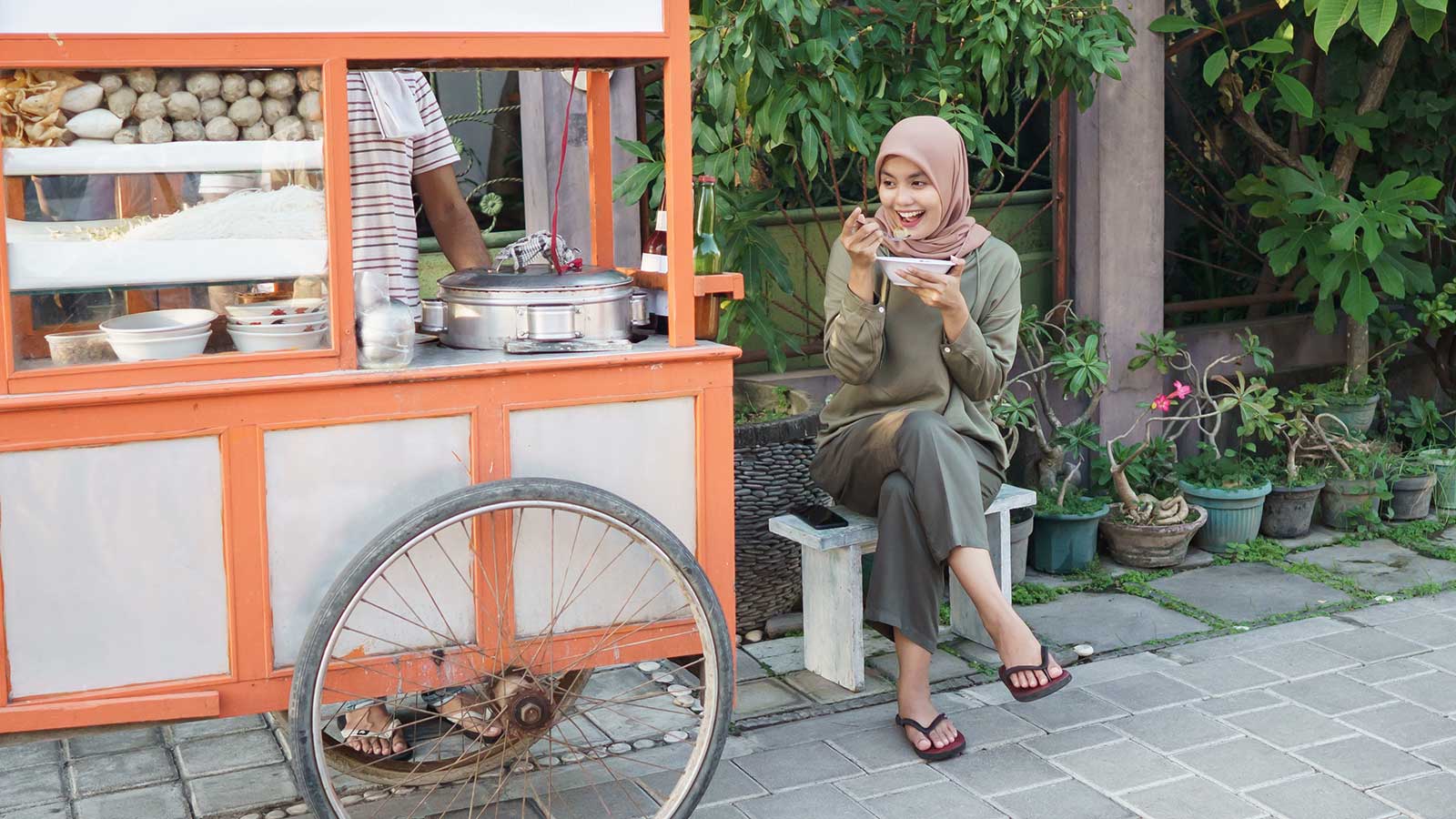 Woman eating at a mobile food cart