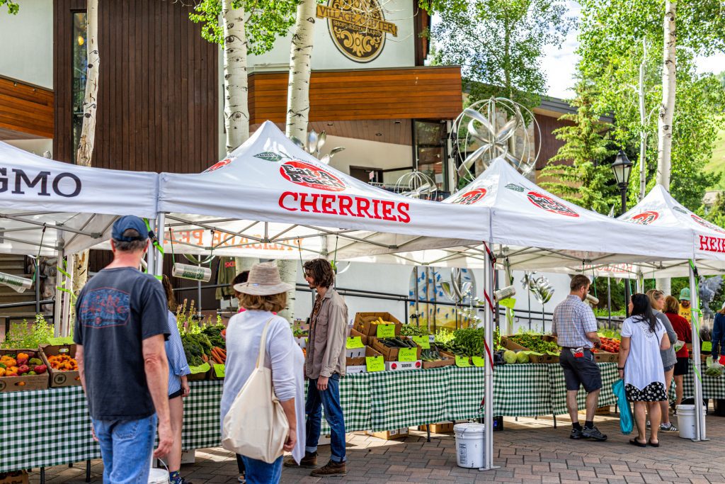 Farmer's market in Colorado with food vendors local stall for fruit.